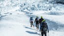 Group of people hiking towards the ice falls.