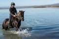 Horseback riding in Iceland in a river
