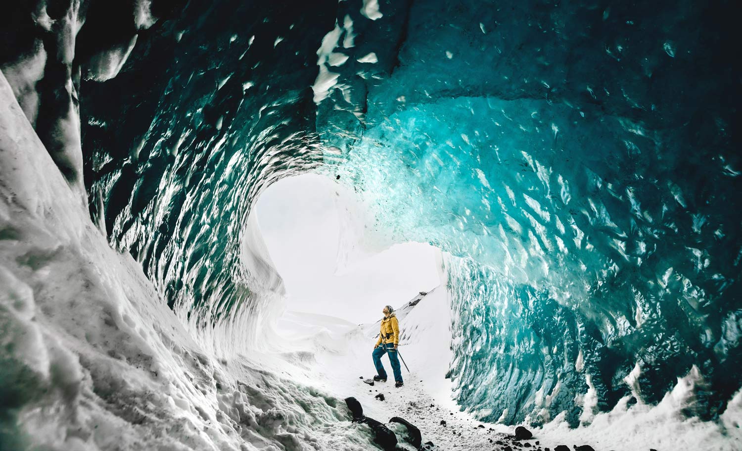 A man standing in an ice cave 
