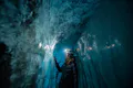 Woman inside an ice cave.
