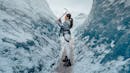 Woman ice picking glacier ice with an ice axe.