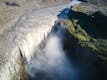 Aerial view of the biggest waterfall in Iceland, this waterfall falls into a canyon that is surrounded with moss.