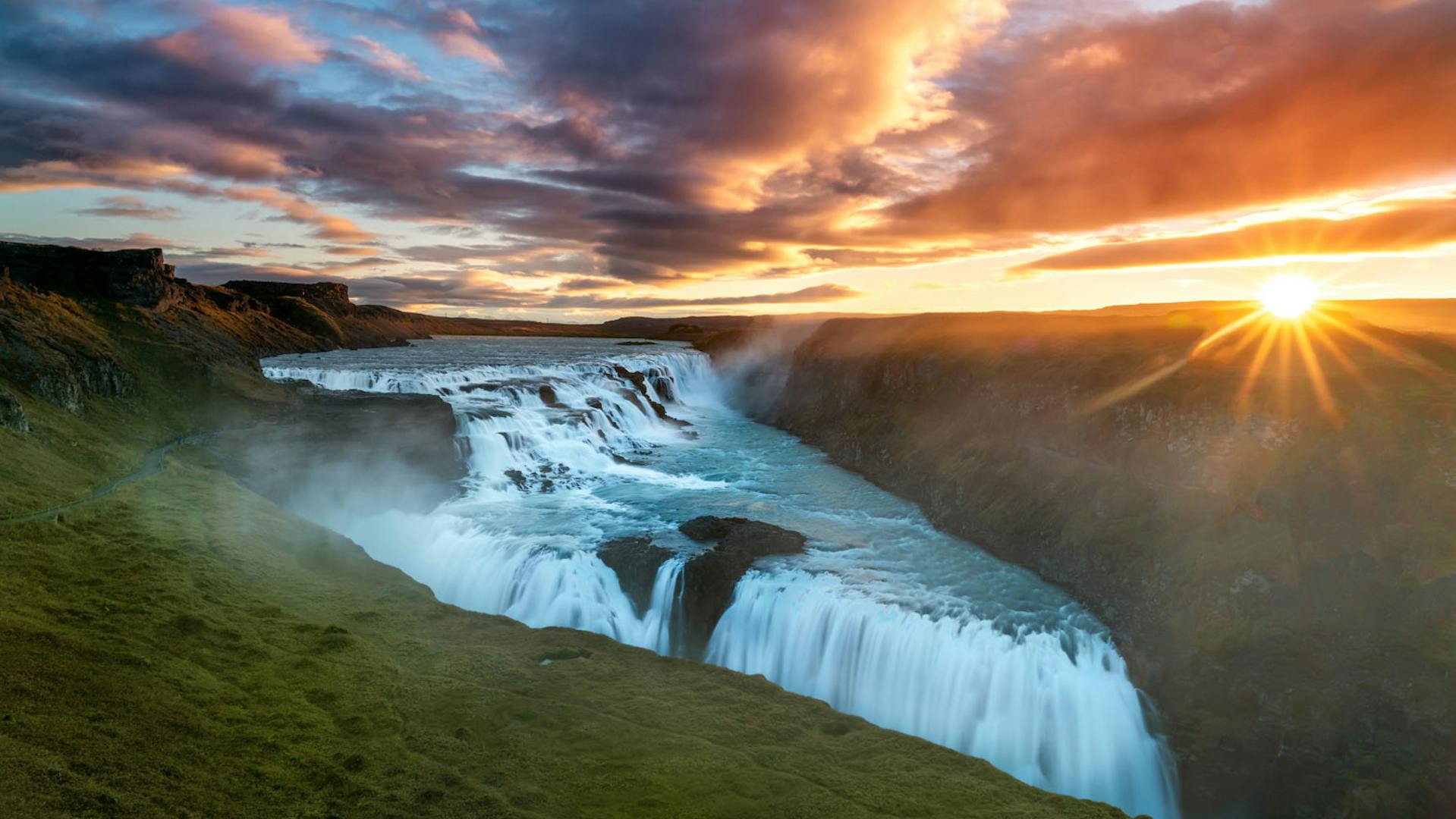 Powerfull waterfall on a canyon during the sunrise.