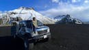 Woman sitting on top of a super jeep with Star Wars scenery on the background.