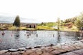 People bathing in Secret Lagoon in Iceland, geothermal hot spring.