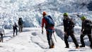 A group of people hiking on a galcier.