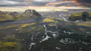 Aerial photograph of a glacier and mountains in the background.