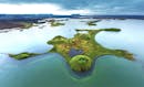 a big lake with craters and small islands in the north of Iceland.